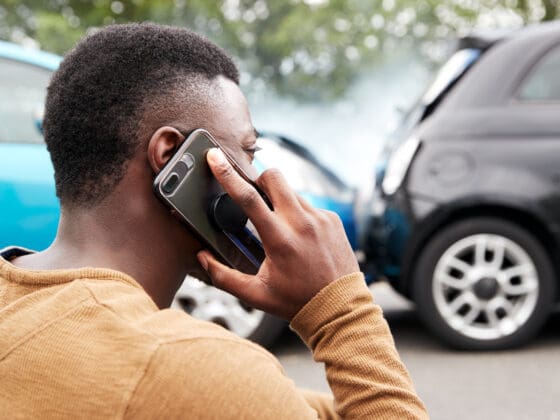 Male Motorist Involved In Car Accident Calling Insurance Company Or Recovery Service
