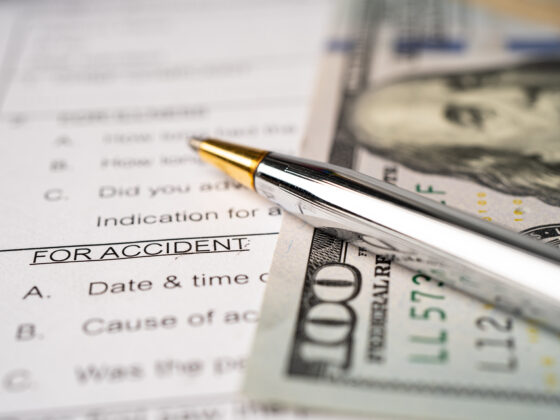 Insurance claim accident car form with US dollar banknote, Car loan, insurance and leasing time concepts.