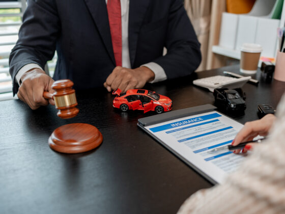 A car accident lawyer is explaining the details of a car insurance policy to the car owner before she signs it, a lawyer explains to his client what will happen if she doesn't get car insurance